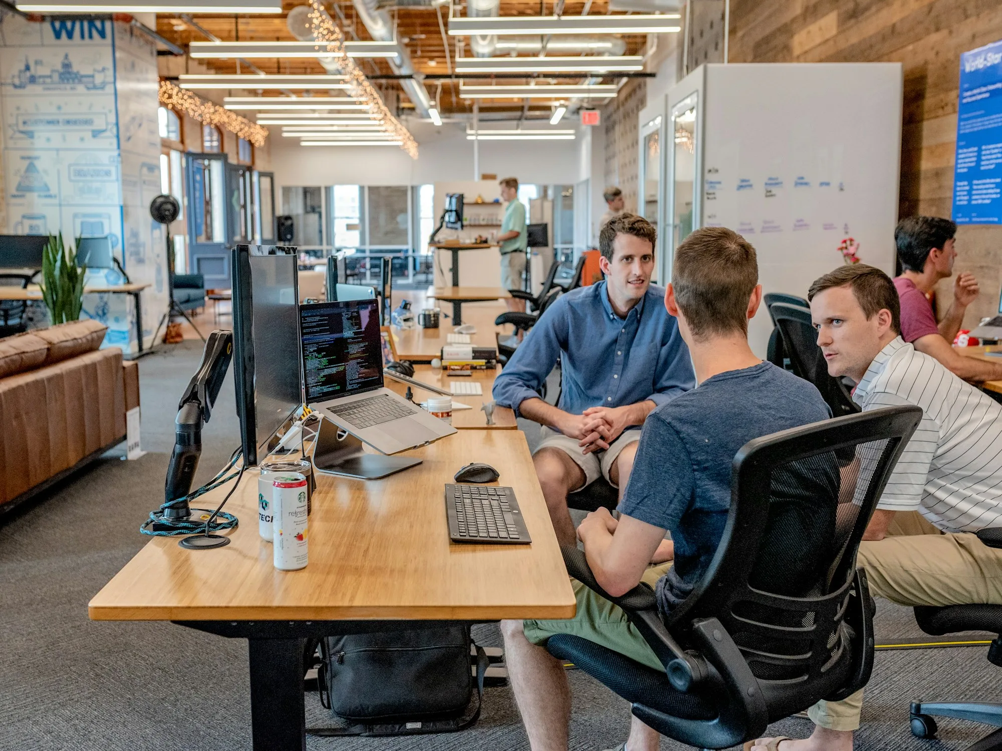 Operations team collaborating at desks in an office