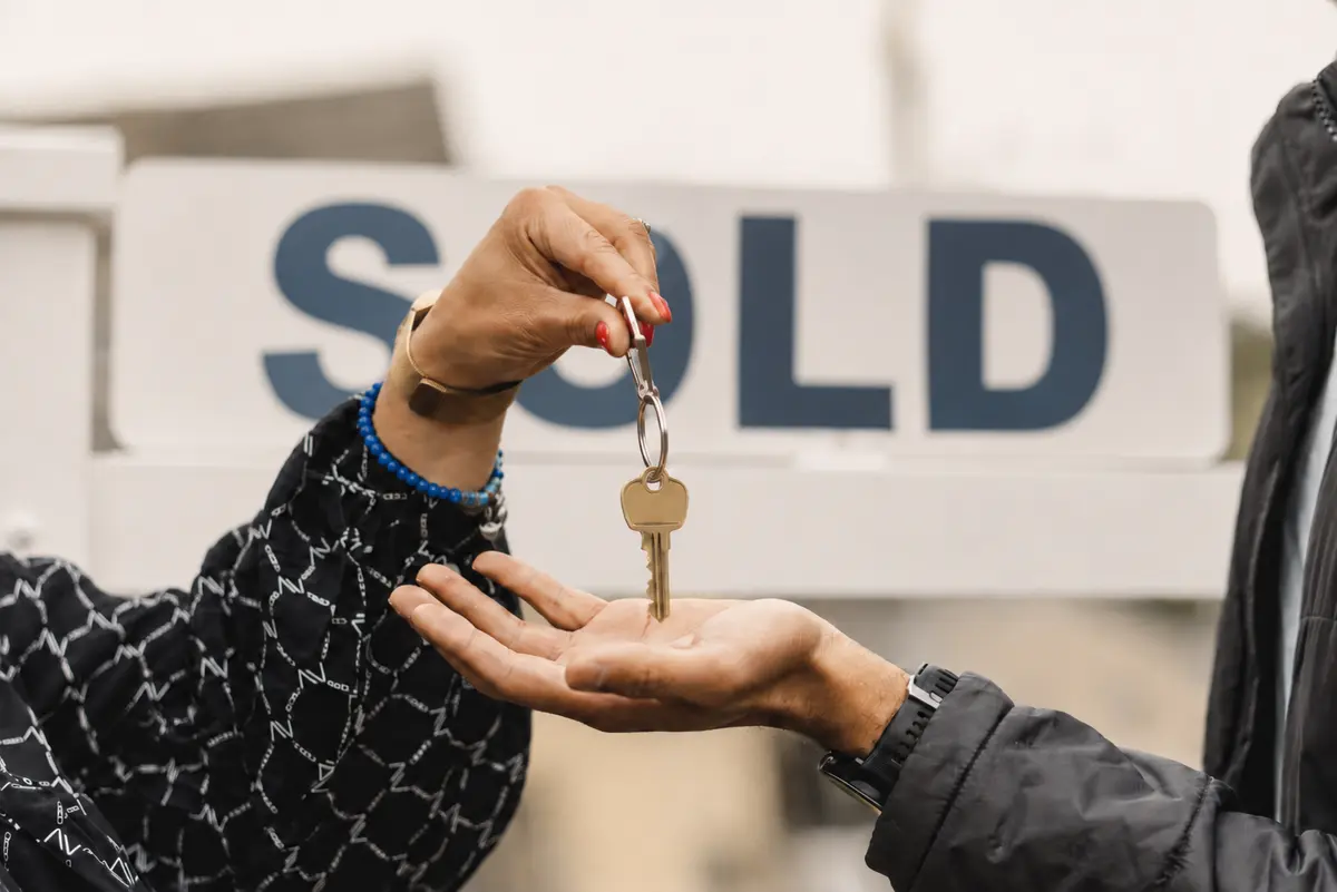 Real estate agent handing a homebuyer the keys